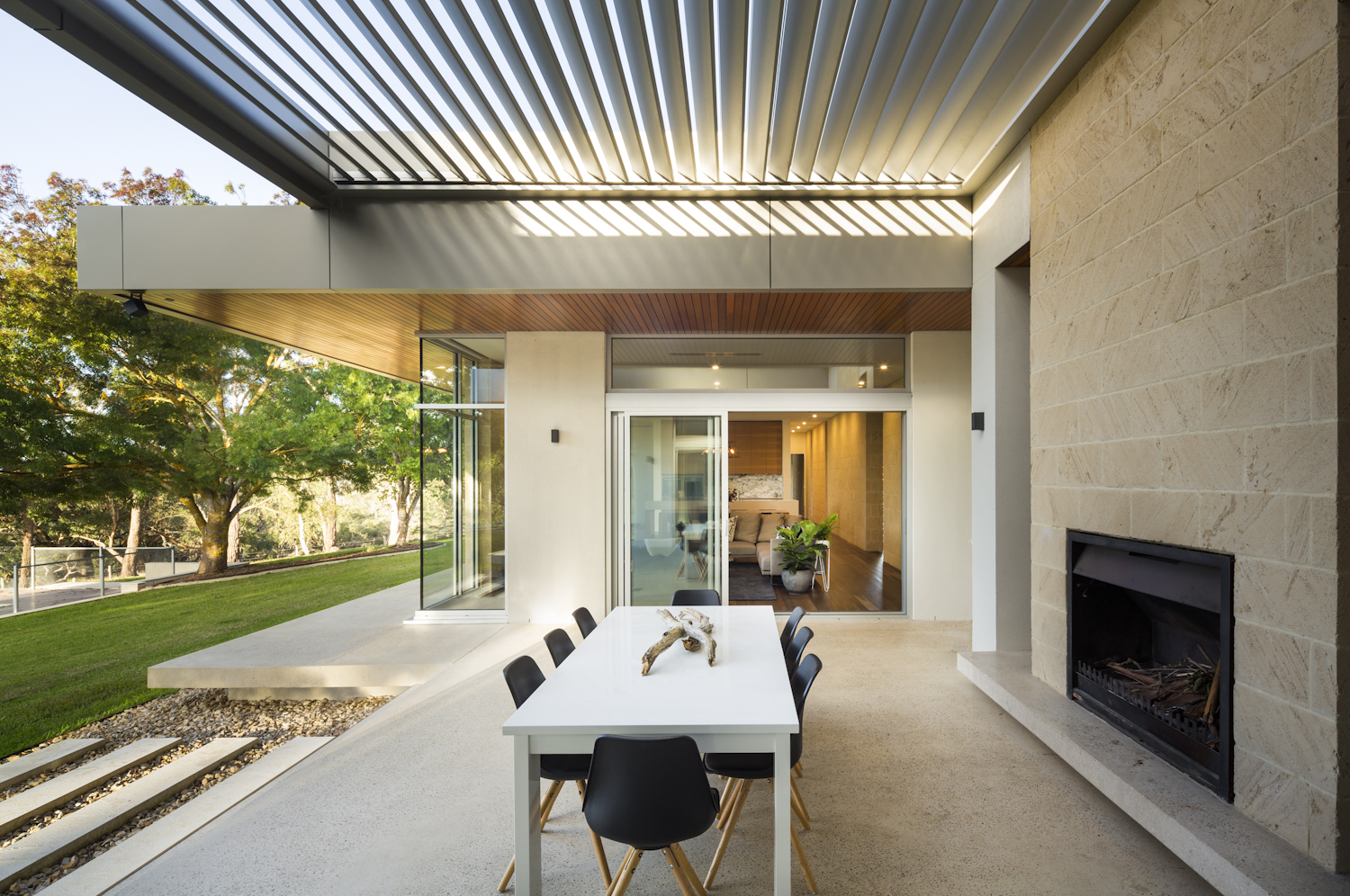 Alfresco entertaining area with louvre roof and outdoor fireplace